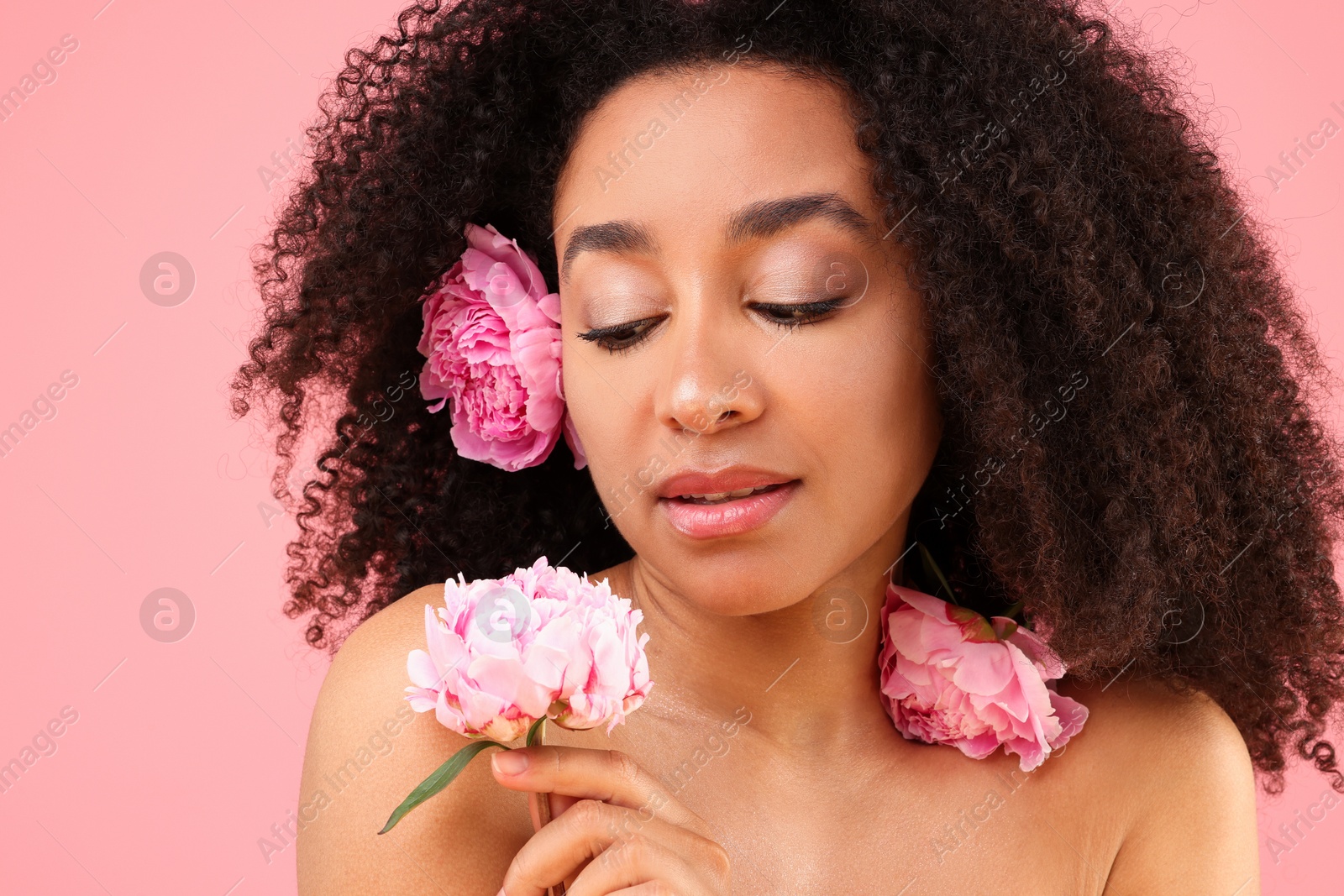Beautiful Brazilian woman with peonies on pink background Photo of Beautiful Brazilian woman with peonies on pink background