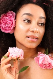 Photo of Beautiful Brazilian woman with peony flowers, closeup
