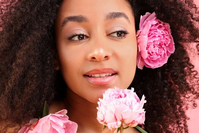 Photo of Beautiful Brazilian woman with peony flowers, closeup