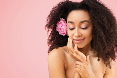 Photo of Beautiful Brazilian woman with peony flower on pink background, space for text