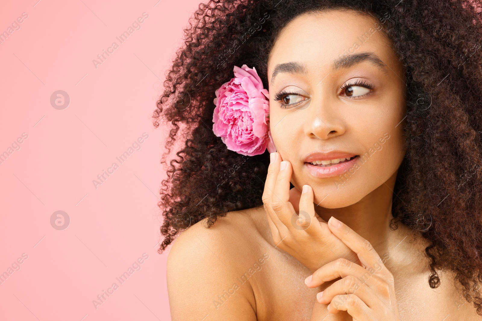 Beautiful Brazilian woman with peony flower on pink background, closeup. Space for text Photo of Beautiful Brazilian woman with peony flower on pink background, closeup. Space for text