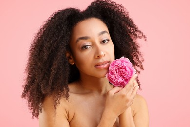 Photo of Beautiful Brazilian woman with peony flower on pink background