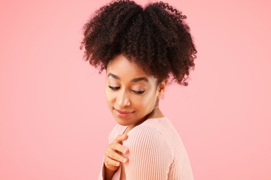 Photo of Portrait of beautiful Brazilian woman on pink background