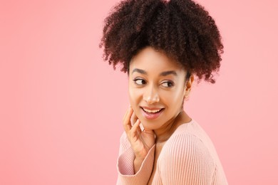 Photo of Portrait of beautiful Brazilian woman on pink background