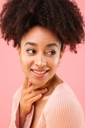 Photo of Portrait of beautiful Brazilian woman on pink background