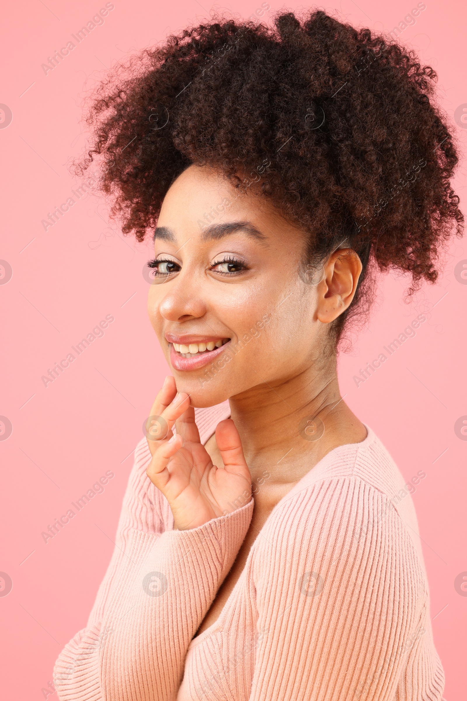 Portrait of beautiful Brazilian woman on pink background Photo of Portrait of beautiful Brazilian woman on pink background