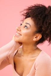Photo of Portrait of beautiful Brazilian woman on pink background