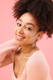 Photo of Portrait of beautiful Brazilian woman on pink background