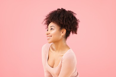 Photo of Portrait of beautiful Brazilian woman on pink background