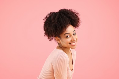Photo of Portrait of beautiful Brazilian woman on pink background