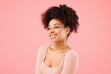 Photo of Portrait of beautiful Brazilian woman on pink background