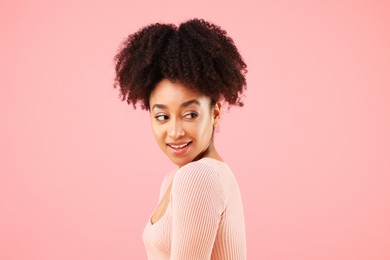 Photo of Portrait of beautiful Brazilian woman on pink background