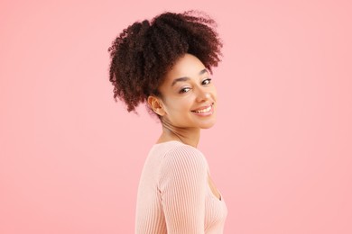 Photo of Portrait of beautiful Brazilian woman on pink background