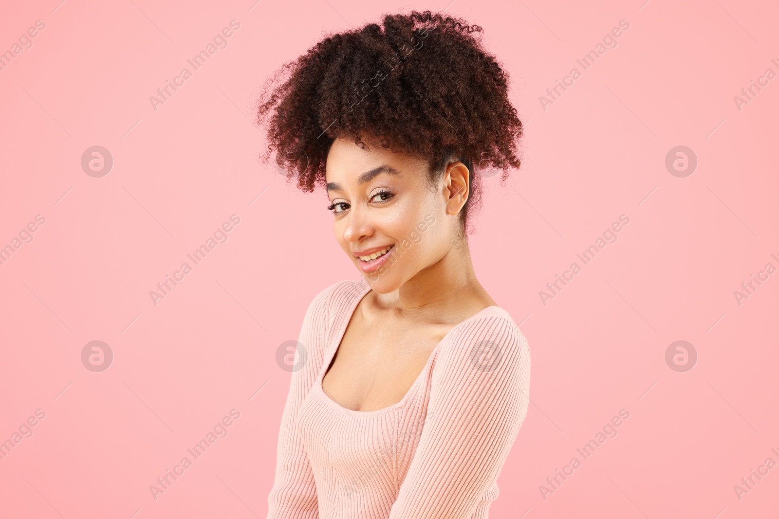 Portrait of beautiful Brazilian woman on pink background Photo of Portrait of beautiful Brazilian woman on pink background