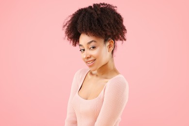 Photo of Portrait of beautiful Brazilian woman on pink background