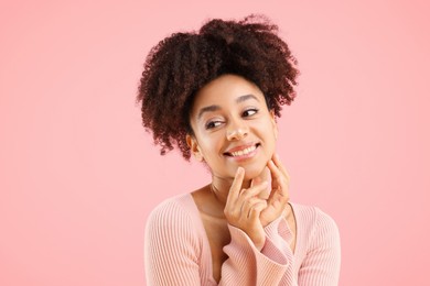Photo of Portrait of beautiful Brazilian woman on pink background