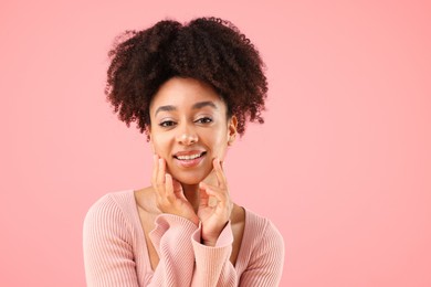 Photo of Portrait of beautiful Brazilian woman on pink background