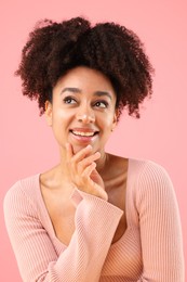 Photo of Portrait of beautiful Brazilian woman on pink background