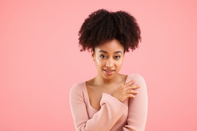 Photo of Portrait of beautiful Brazilian woman on pink background