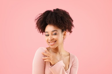 Photo of Portrait of beautiful Brazilian woman on pink background