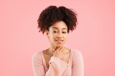 Photo of Portrait of beautiful Brazilian woman on pink background