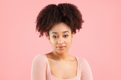 Photo of Portrait of beautiful Brazilian woman on pink background