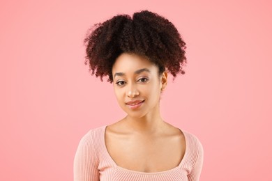 Photo of Portrait of beautiful Brazilian woman on pink background
