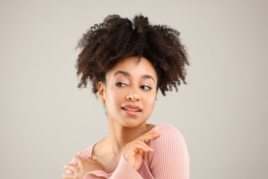 Photo of Portrait of beautiful Brazilian woman on gray background