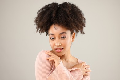 Photo of Portrait of beautiful Brazilian woman on gray background