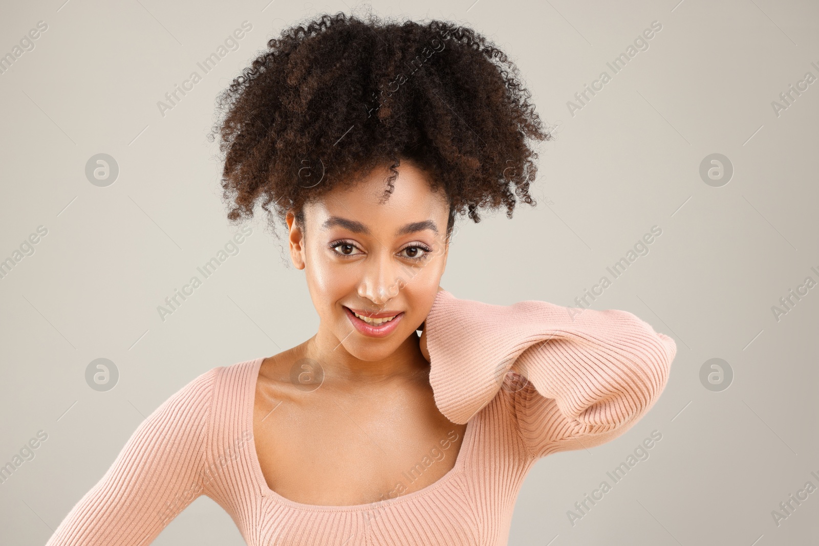 Portrait of beautiful Brazilian woman on gray background Photo of Portrait of beautiful Brazilian woman on gray background
