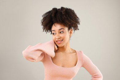 Photo of Portrait of beautiful Brazilian woman on gray background