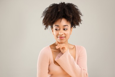 Photo of Portrait of beautiful Brazilian woman on gray background