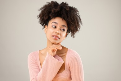 Photo of Portrait of beautiful Brazilian woman on gray background
