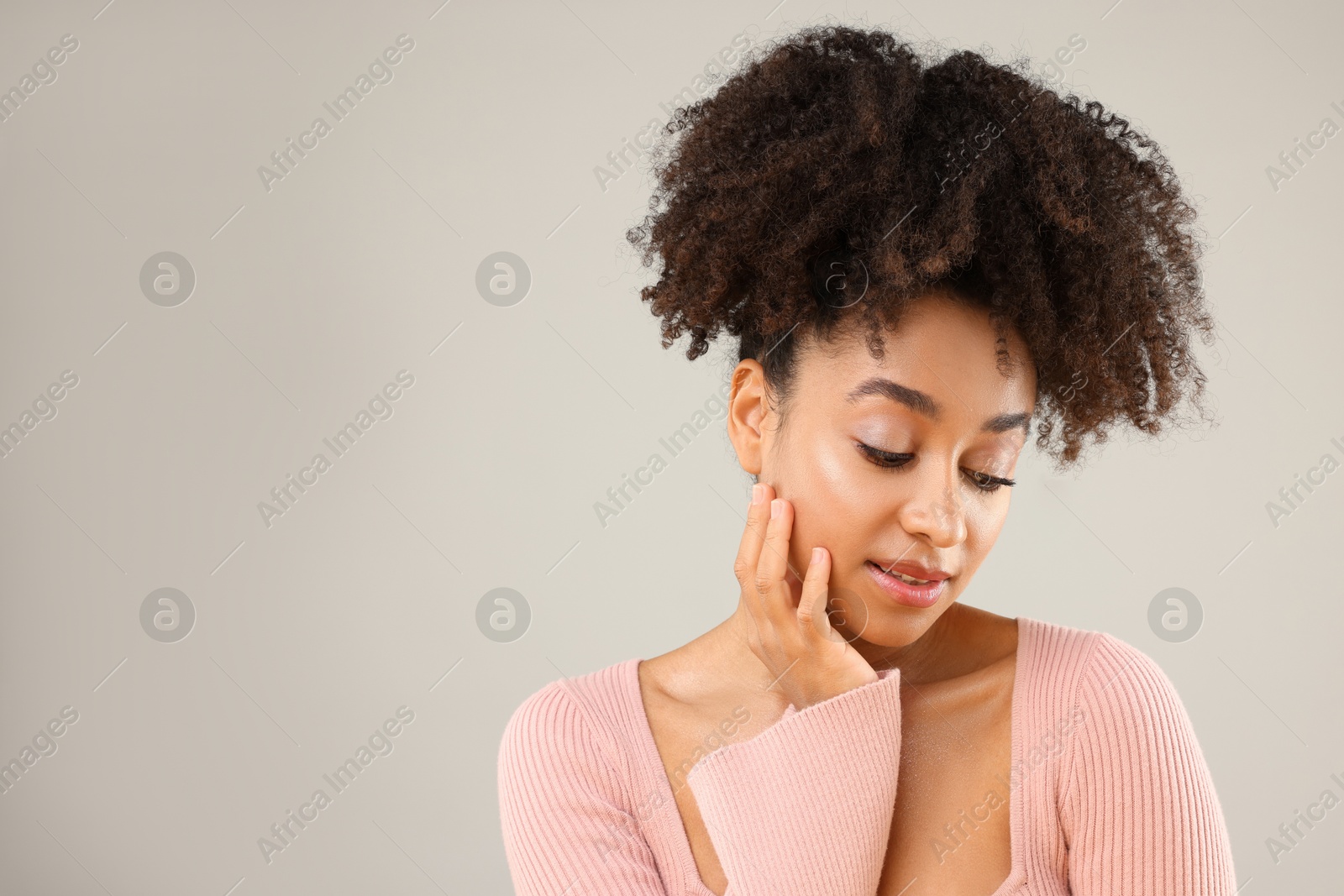 Portrait of beautiful Brazilian woman on gray background, space for text Photo of Portrait of beautiful Brazilian woman on gray background, space for text