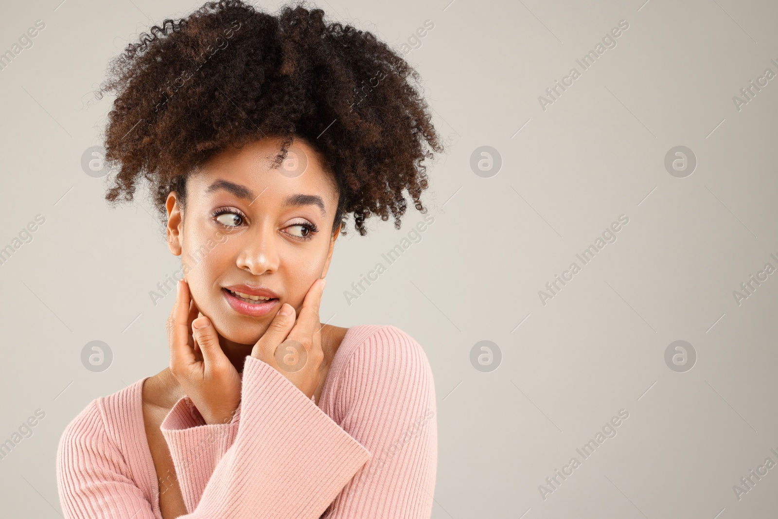 Portrait of beautiful Brazilian woman on gray background, space for text Photo of Portrait of beautiful Brazilian woman on gray background, space for text