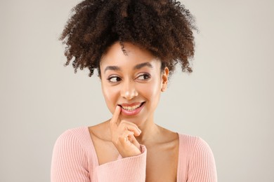 Photo of Portrait of beautiful Brazilian woman on gray background