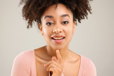 Photo of Portrait of beautiful Brazilian woman on gray background, closeup