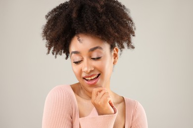 Photo of Portrait of beautiful Brazilian woman on gray background