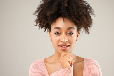 Photo of Portrait of beautiful Brazilian woman on gray background