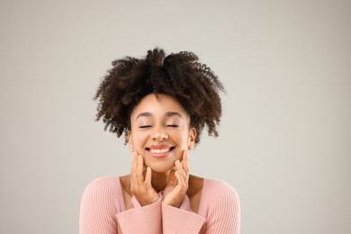 Photo of Portrait of beautiful Brazilian woman on gray background