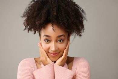 Photo of Portrait of beautiful Brazilian woman on gray background