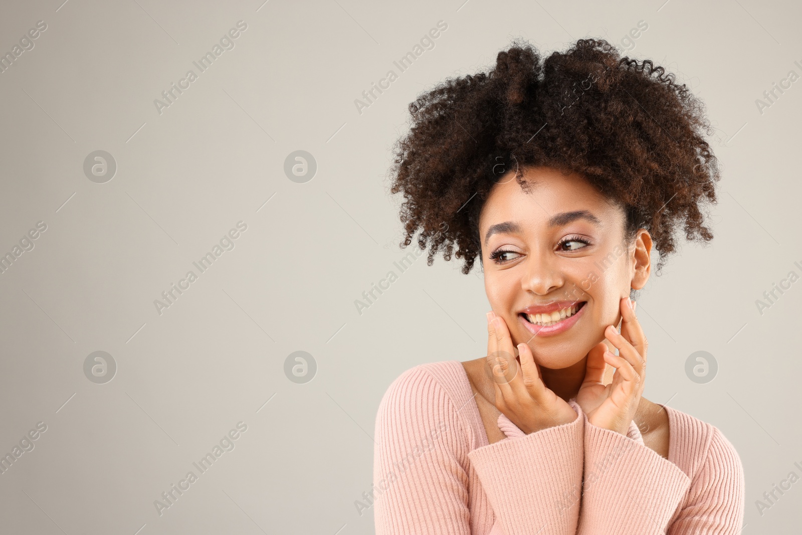 Portrait of beautiful Brazilian woman on gray background, space for text Photo of Portrait of beautiful Brazilian woman on gray background, space for text