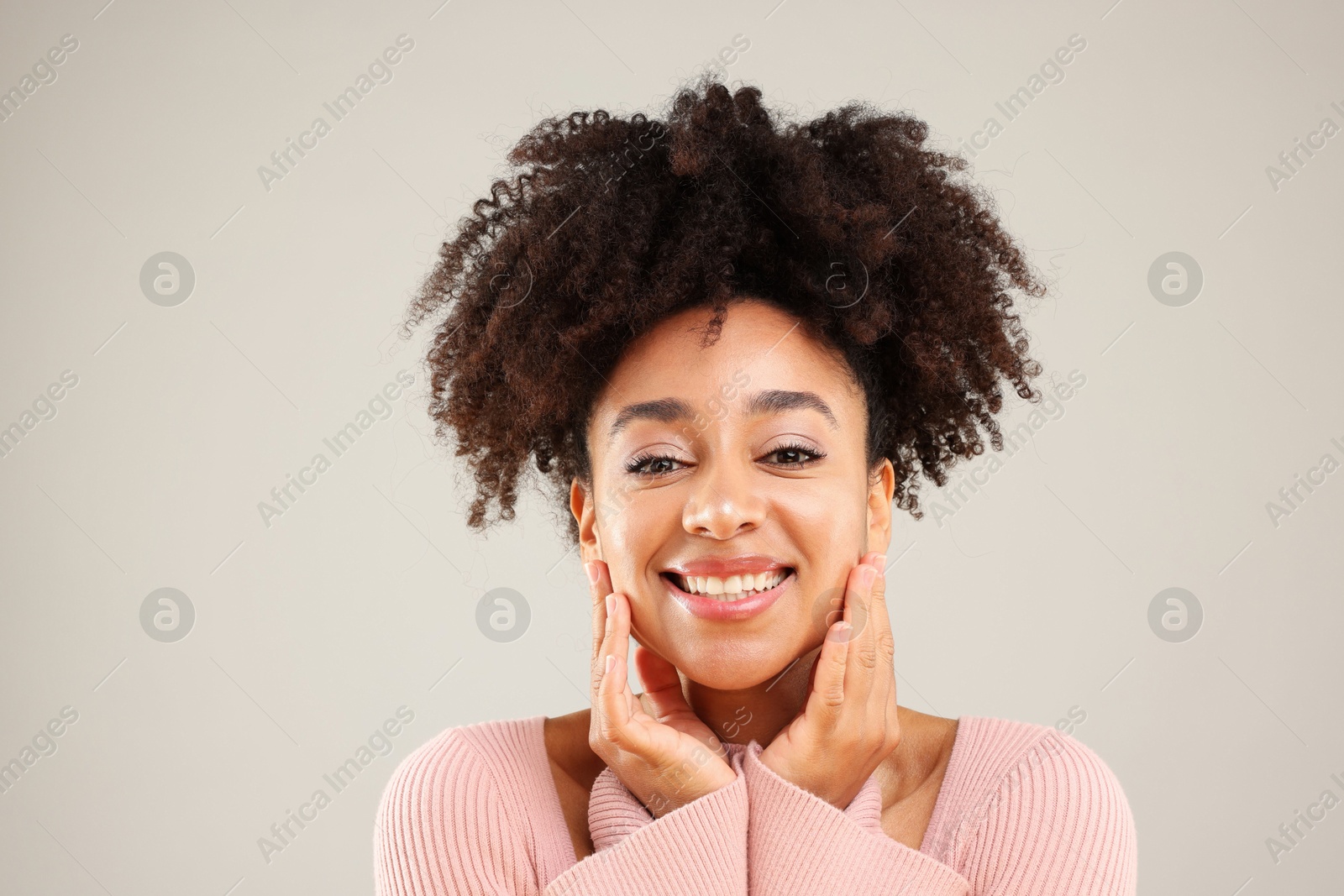 Portrait of beautiful Brazilian woman on gray background Photo of Portrait of beautiful Brazilian woman on gray background