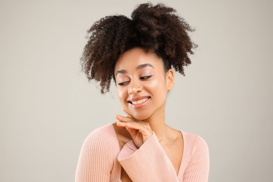 Photo of Portrait of beautiful Brazilian woman on gray background