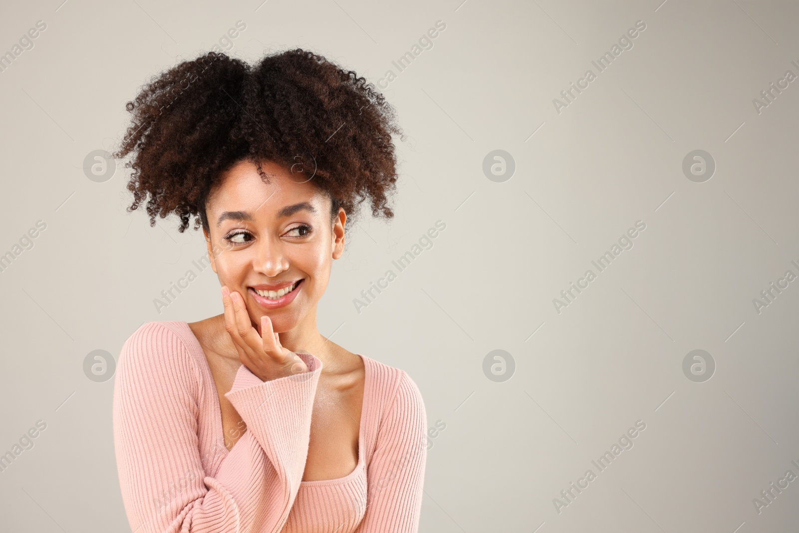 Portrait of beautiful Brazilian woman on gray background, space for text Photo of Portrait of beautiful Brazilian woman on gray background, space for text