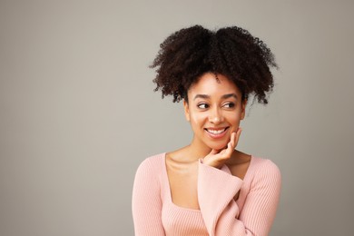 Photo of Portrait of beautiful Brazilian woman on gray background, space for text