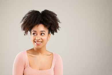 Photo of Portrait of beautiful Brazilian woman on gray background, space for text