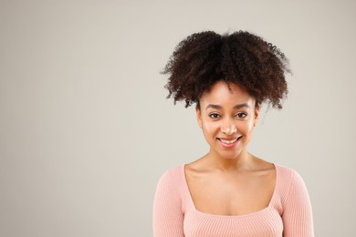 Photo of Portrait of beautiful Brazilian woman on gray background, space for text