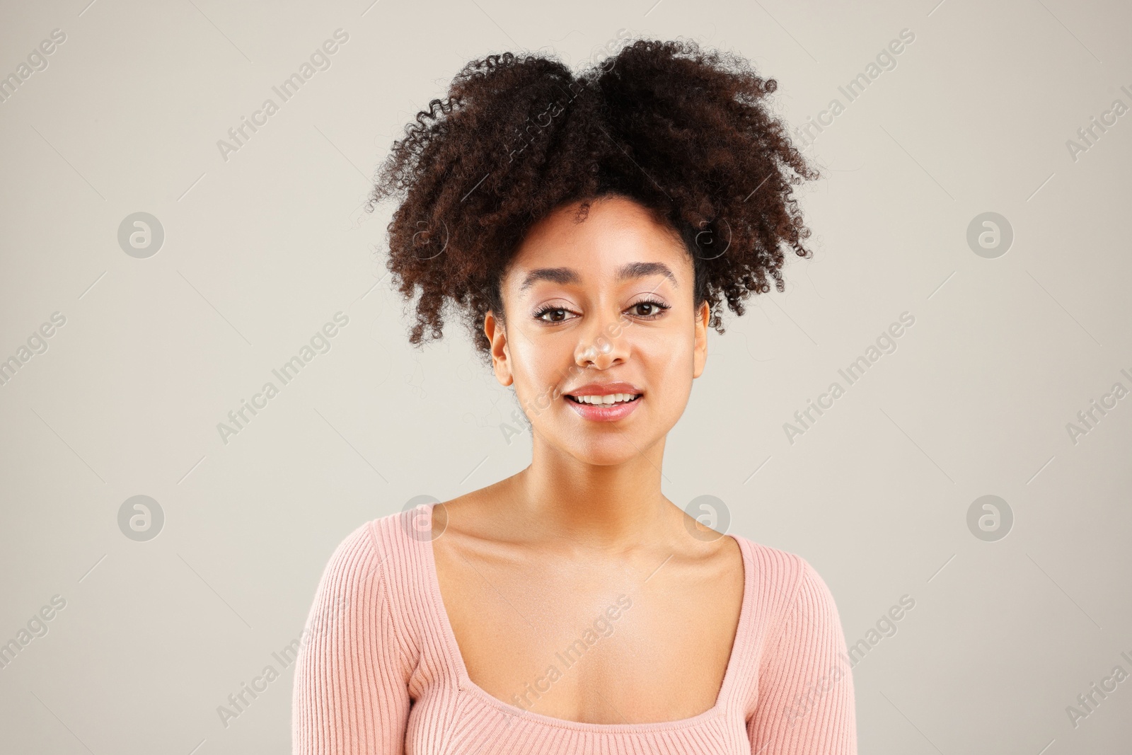 Portrait of beautiful Brazilian woman on gray background Photo of Portrait of beautiful Brazilian woman on gray background