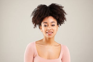 Photo of Portrait of beautiful Brazilian woman on gray background